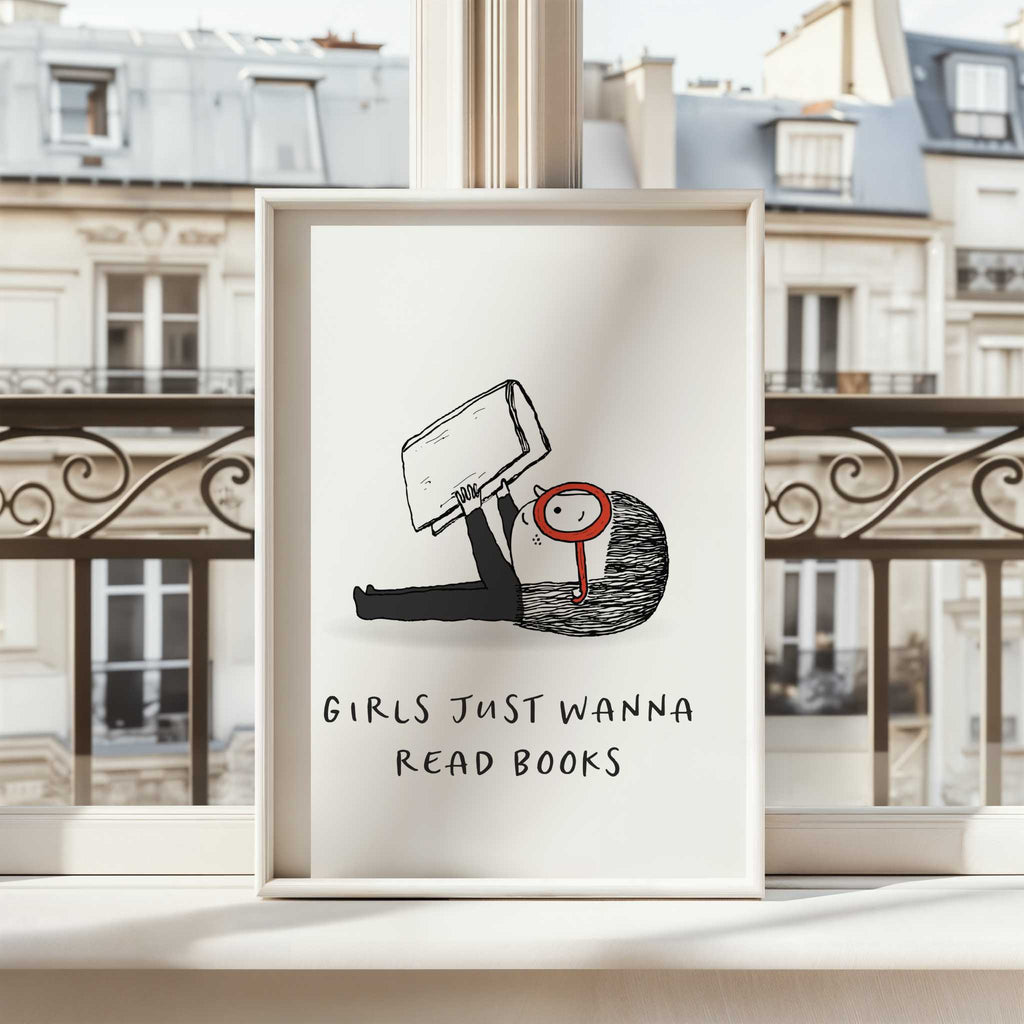 Framed artwork with a illustration of a person holding a book and text 'Girls just wanna read books' against a cityscape background.