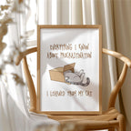 Framed print with a cat illustration and text about procrastination, on a wooden chair.