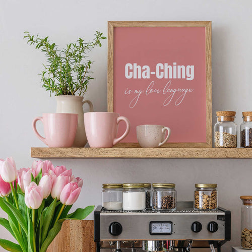 Shelf with pink mugs, a plant, a framed quote, and a coffee machine.