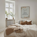 Botanical custom name wall art hung on a bedroom wall. A floral print in a soft palette.