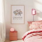 Bedroom with pink and white striped bedding, nightstand, and wall art with text 'Creator Driven by dreams.'