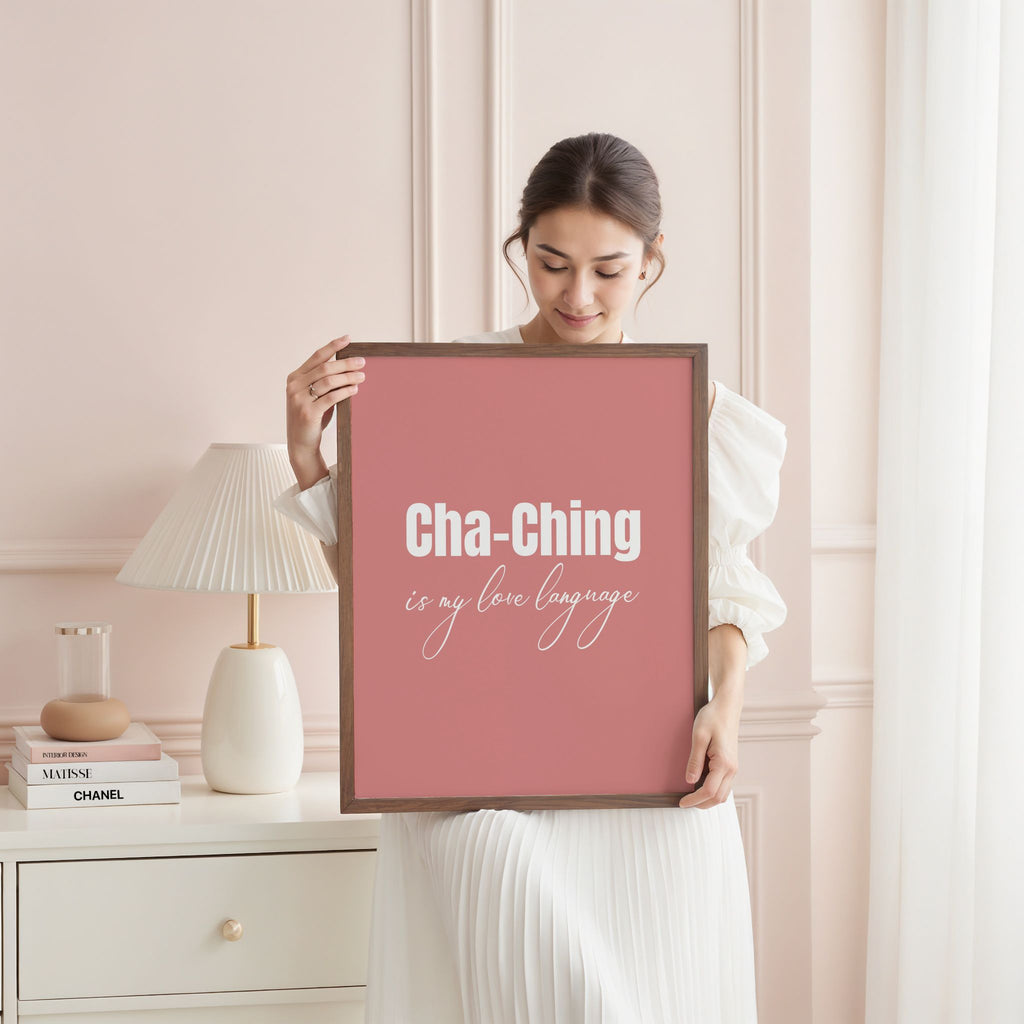 Woman holding a framed quote in a stylish bedroom.