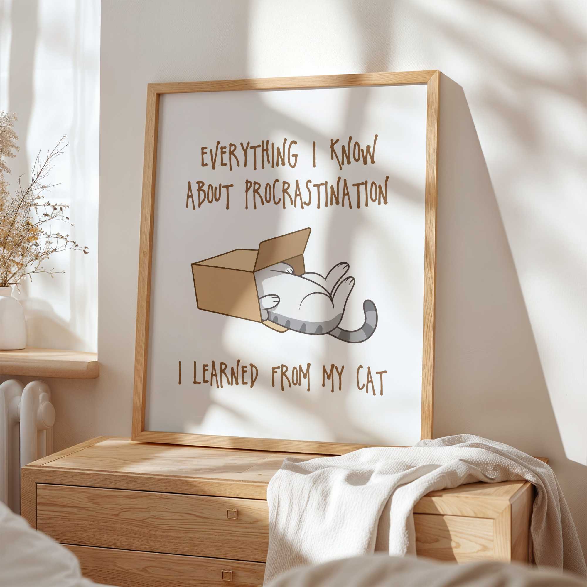 Framed artwork with a cat illustration and text about procrastination on a wall in a bedroom.