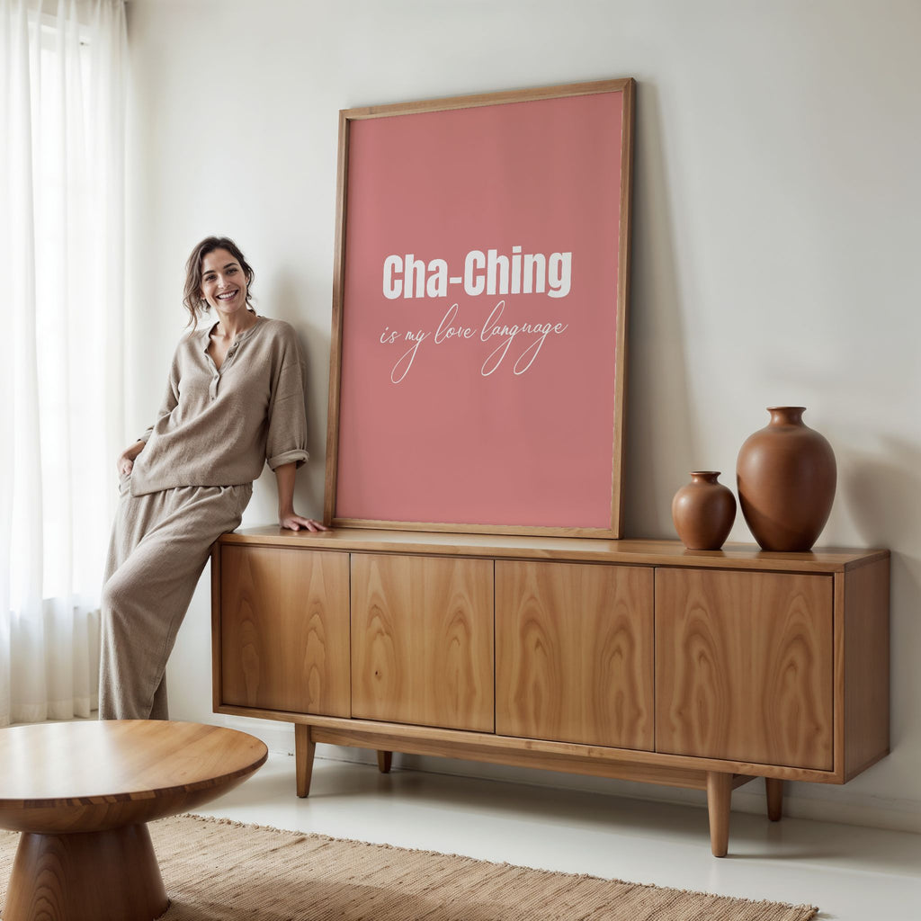 Woman standing next to a wooden cabinet with a pink framed poster in a living room.