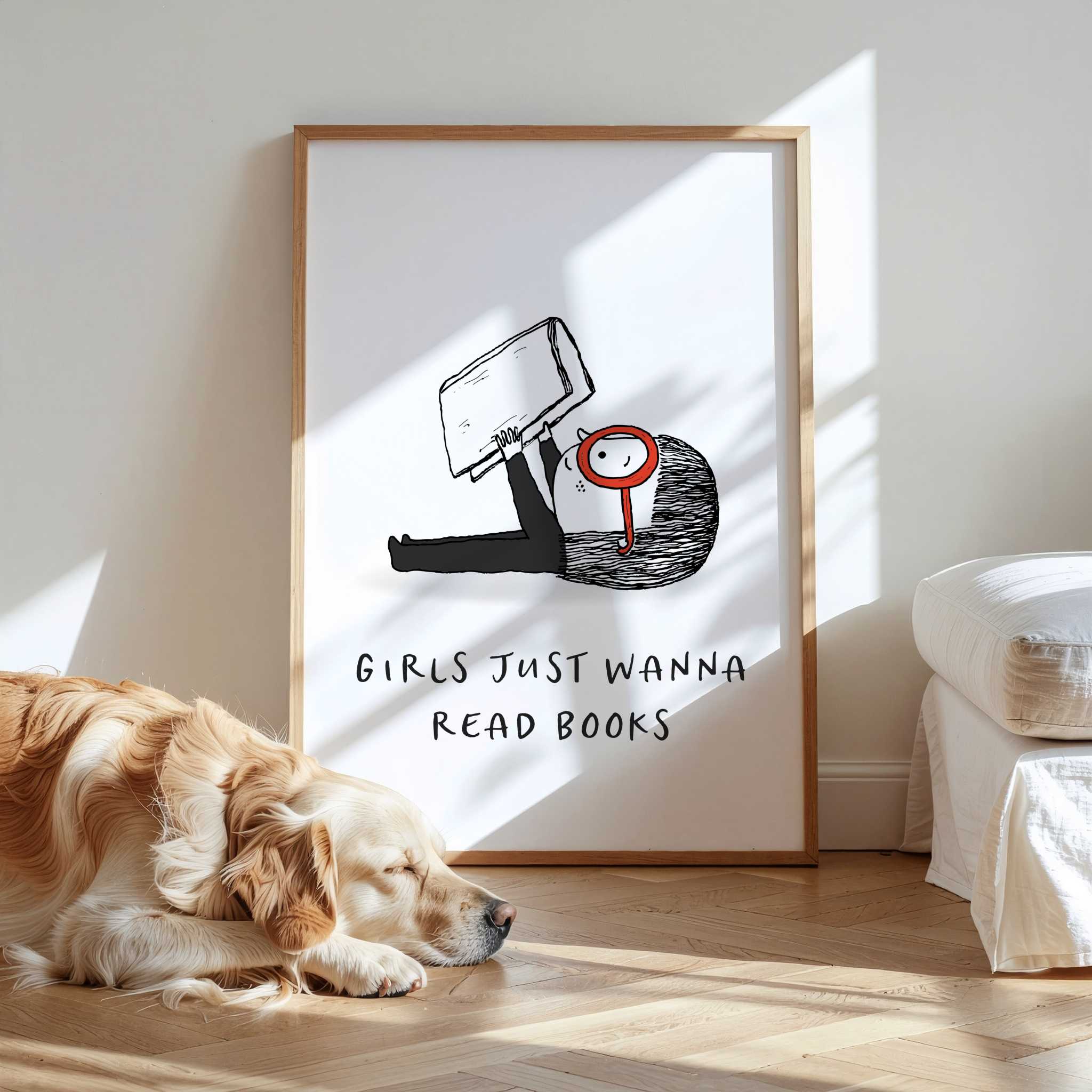 Framed artwork with text 'Girls Just Wanna Read Books" and a dog lying on the floor in front of it