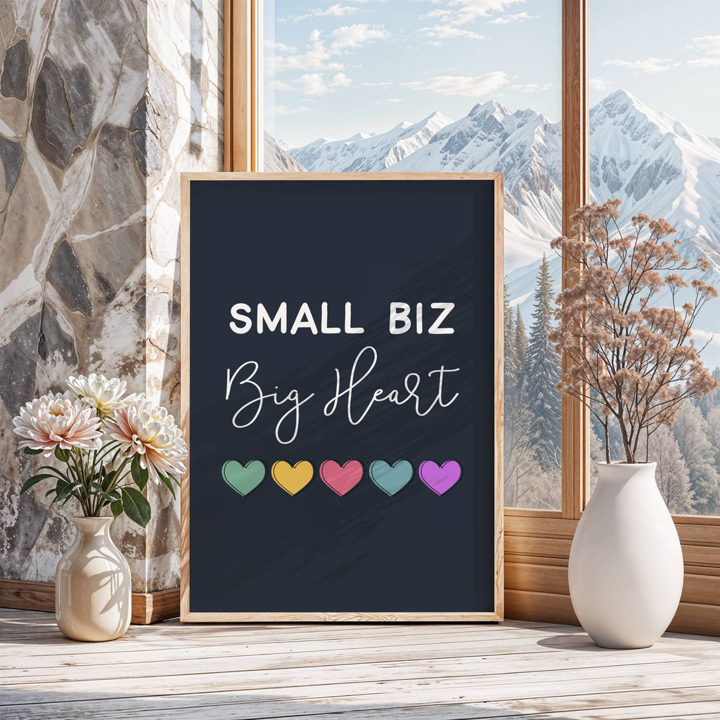 Framed poster with 'Small Biz Big Heart' text and colorful hearts on a window sill with flowers and a vase.