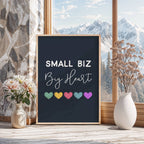 Framed poster with 'Small Biz Big Heart' text and colorful hearts on a window sill with flowers and a vase.