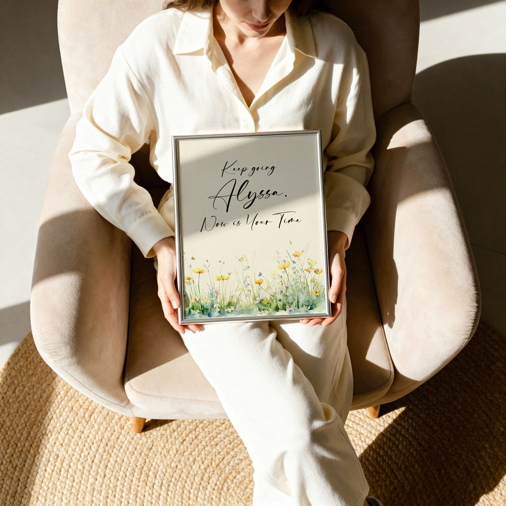 Woman holding a framed motivational quote in a silver frame