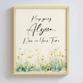 Framed personalized motivational quote with floral design on a light background