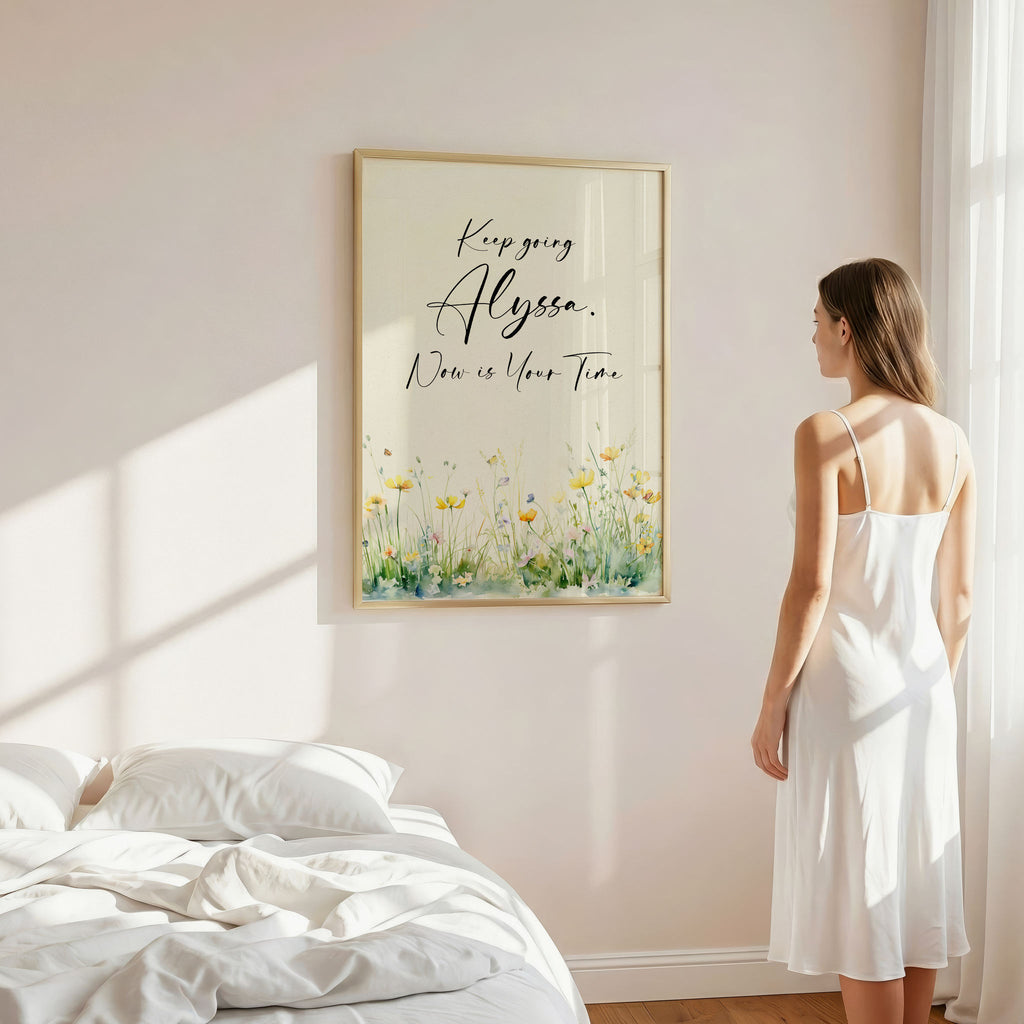 Young woman in a bedroom gazing at a pretty framed motivational art work.