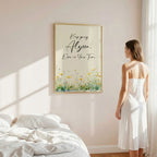 Young woman in a bedroom gazing at a pretty framed motivational art work.